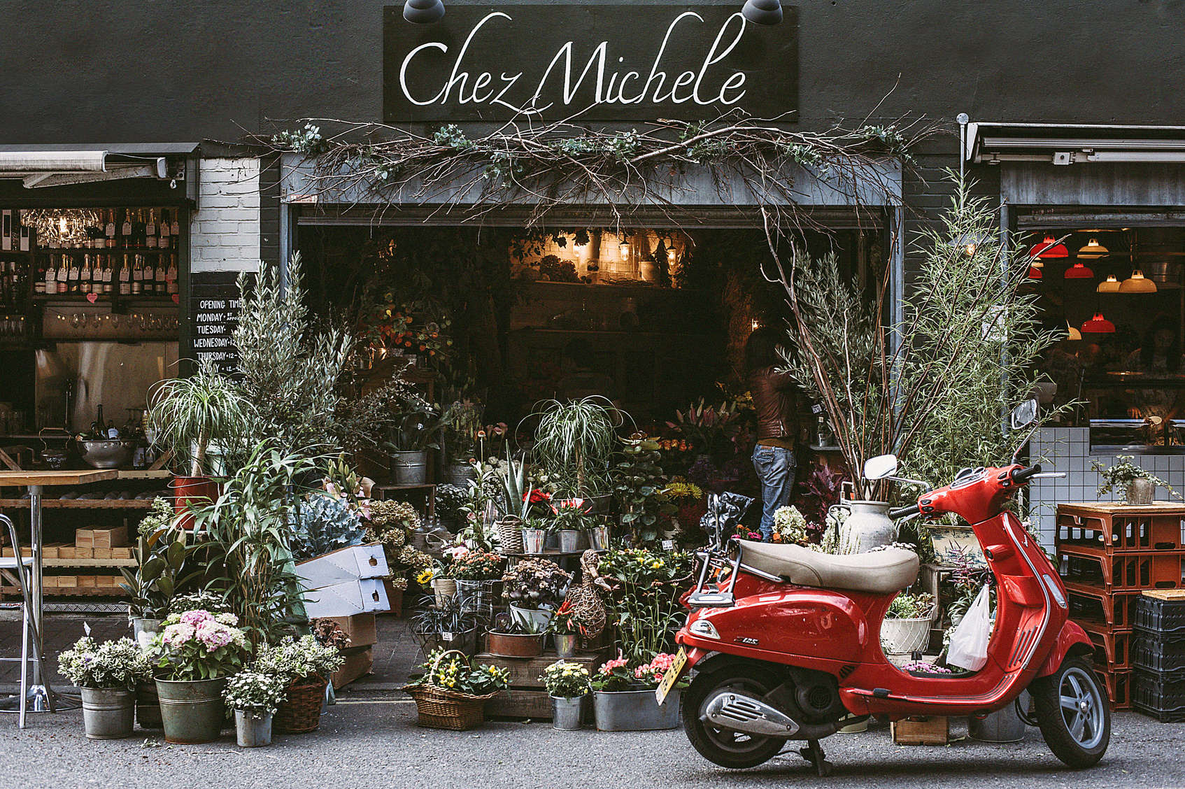 Red Motor Scooter Parking on Front of Chez Michele Store